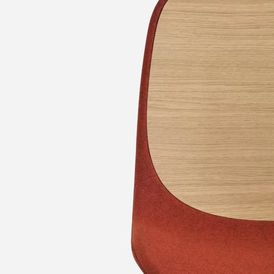 Distinctive Lapalma Seela chair with aerodynamic form upholstered in richly textured reddish-orange fabric and matte light wood panel