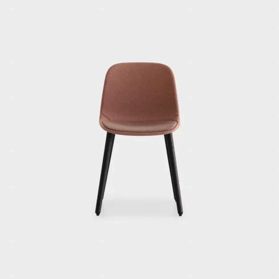 Distinguished Lapalma Seela chair with aerodynamic design upholstered in muted terracotta textile and matte finish with dark metal legs