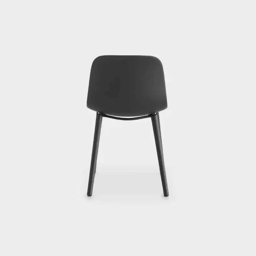 Sophisticated Lapalma Seela chair with aerodynamic design and dark-toned wooden legs crafted in molded matte dark gray plastic