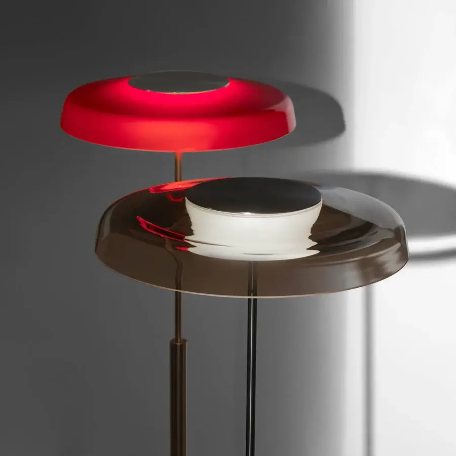 Captivating Oluce Dora floor lamp with tiered shades in red glass and golden-bronze metal, exhibiting a contemporary finish
