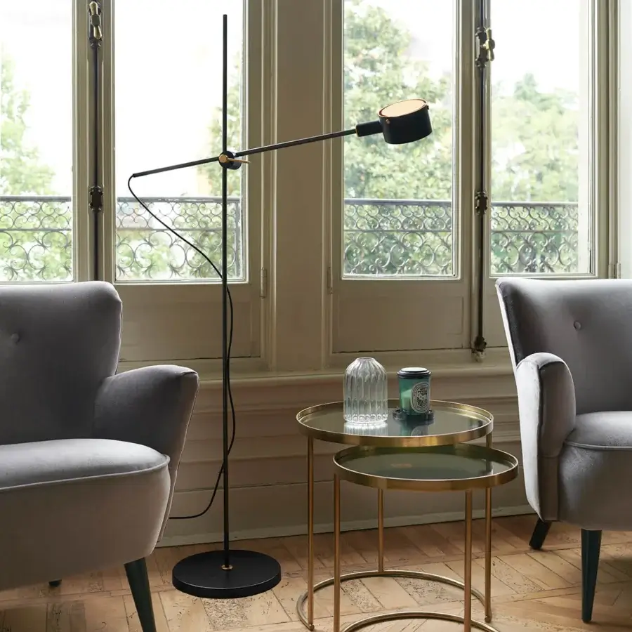 Elegant Oluce G.O Floor Lamp with a slender silhouette and geometric form crafted in matte black metal with a brushed gold-tone adjustable arm
