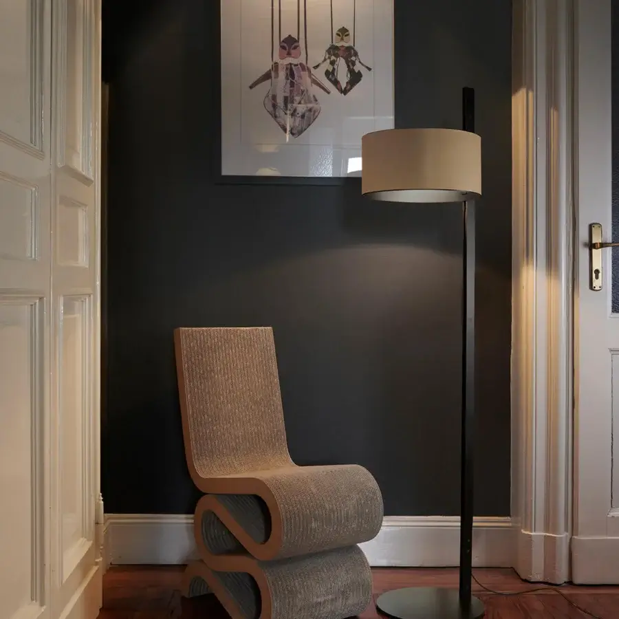 Elegant Oluce Parallel floor lamp with a matte black metallic stem and uniquely finished hammered leather lampshade