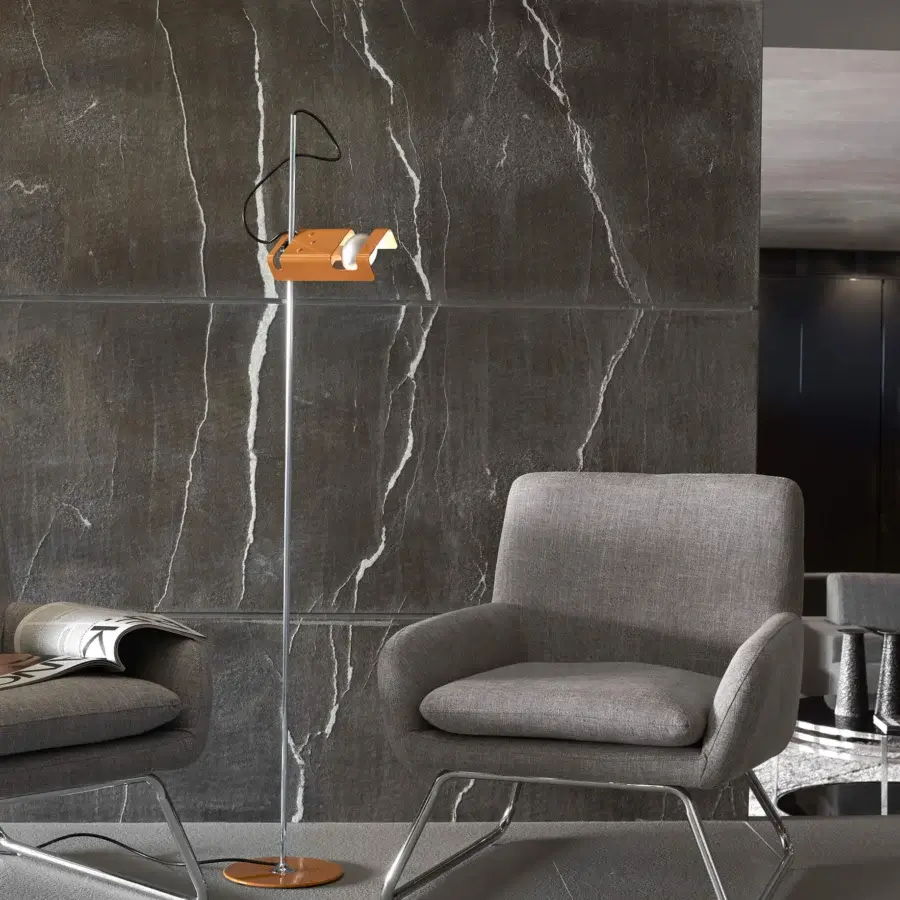 Superior Oluce Spider floor lamp crafted in fire-painted metal with a silver finish and vibrant orange base
