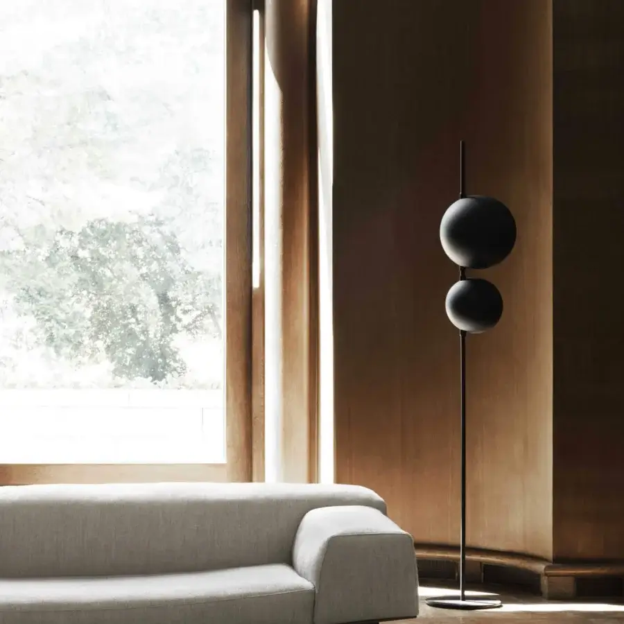 Innovative Oluce Superluna floor lamp crafted in black metal with rotating semi-spherical shades and a matte finish