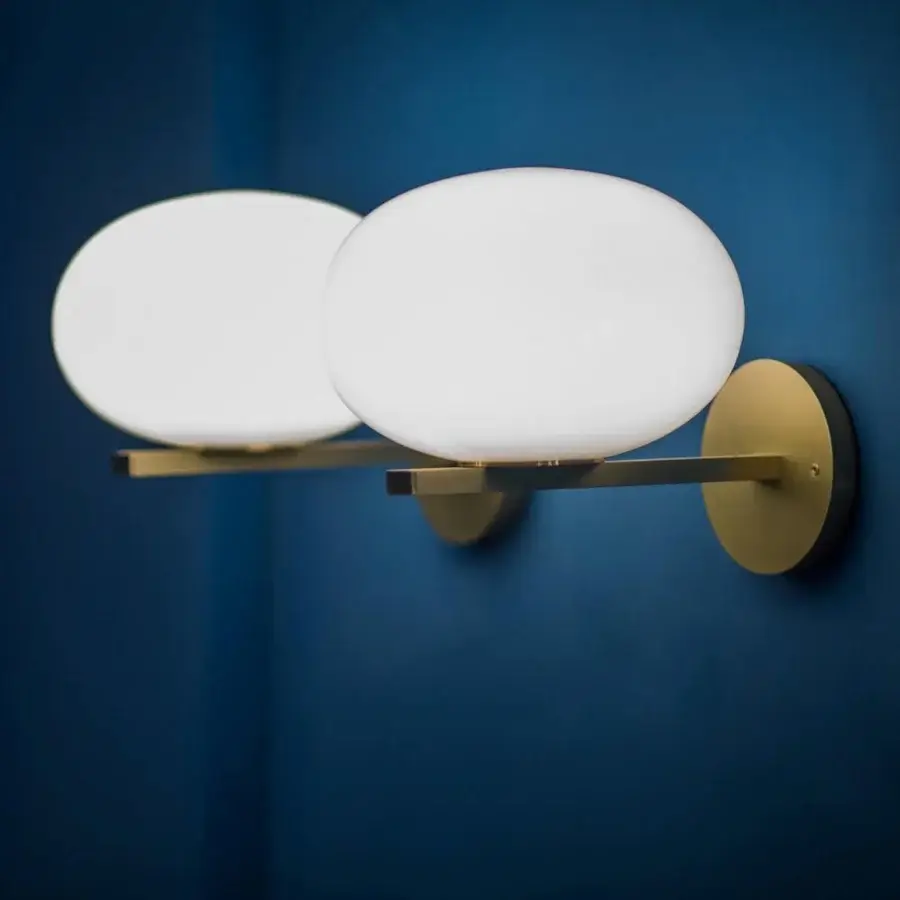 Refined Oluce Alba wall lamp crafted in Italy with satin gold-toned metal and frosted glass shades