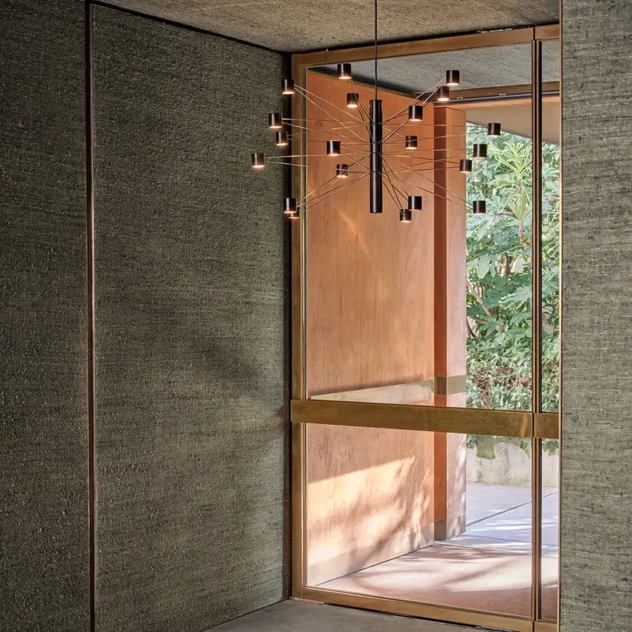 Superior Kundalini Polar Suspension Lamp crafted in metal with a dark matte finish and warm brass light sources
