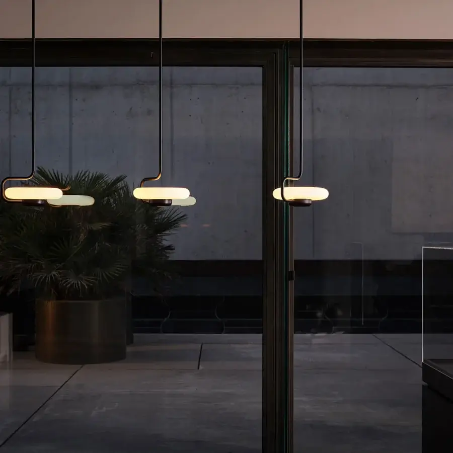 Superior Kundalini Tratto suspension lamp crafted in dark bronze metal and opal glass with a sleek linear silhouette
