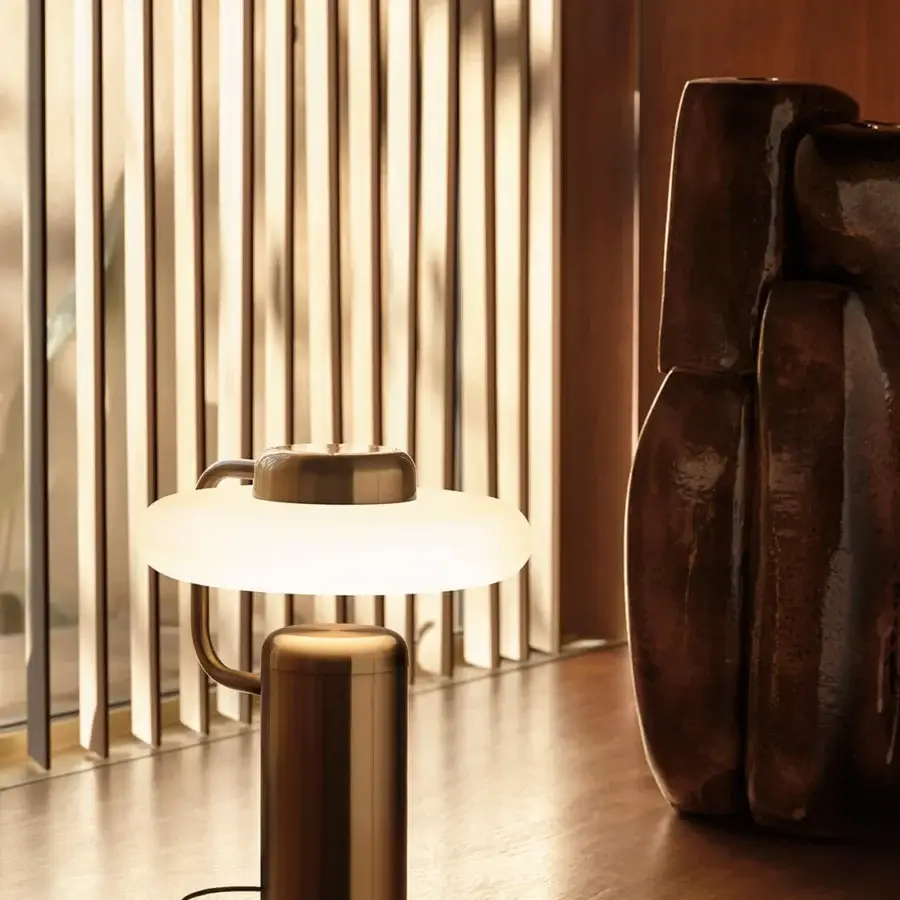 Superior Kundalini Tratto table lamp crafted in elegant metal and opal glass with warm bronze satin finish