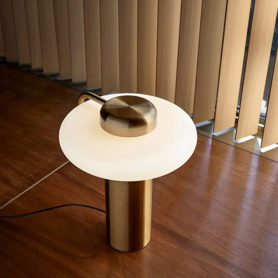 Elegant Kundalini Tratto table lamp crafted in metal and opal glass with a warm golden finish