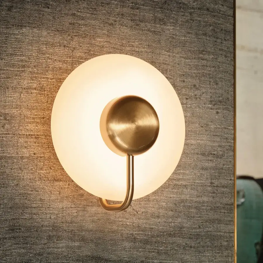 Distinguished Kundalini Tratto wall lamp crafted in brass-toned metal and opal glass with satin finish
