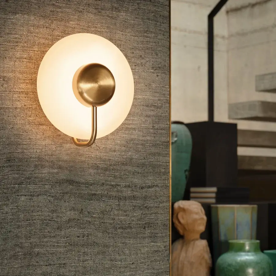 Superior Kundalini Tratto wall lamp crafted in muted brass-toned metal and opal glass with a gently curved silhouette
