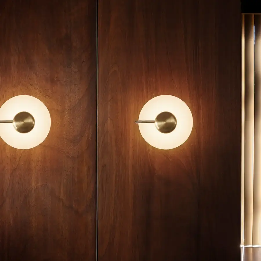 Exclusive Kundalini Tratto wall lamp crafted in muted gold metal with opal glass for a raised graphic effect