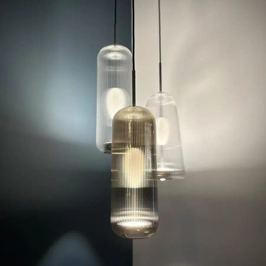 Distinguished melogranoblu Piero suspension lamp crafted in handblown glass with warm amber ribbed finish and dual light source