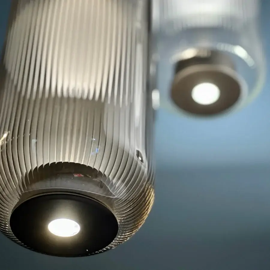Elegant melogranoblu Piero suspension lamp crafted in translucent gray ribbed handblown glass with glossy silver metallic ends