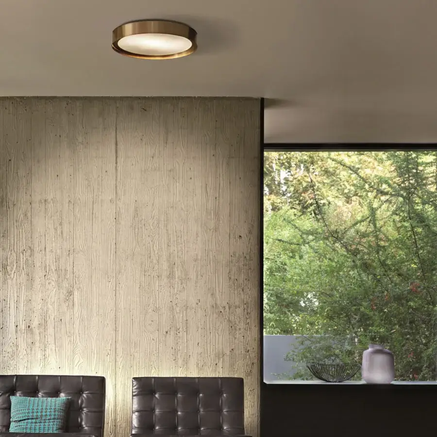 Elegant Oluce Berlin Wall/Ceiling lamp crafted in satin metal with warm gold tone and darker bronze accents