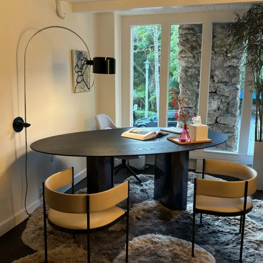 Distinguished Oluce Coupé wall lamp delivering directed light with a sleek matte black metal finish and semi-cylindrical shade