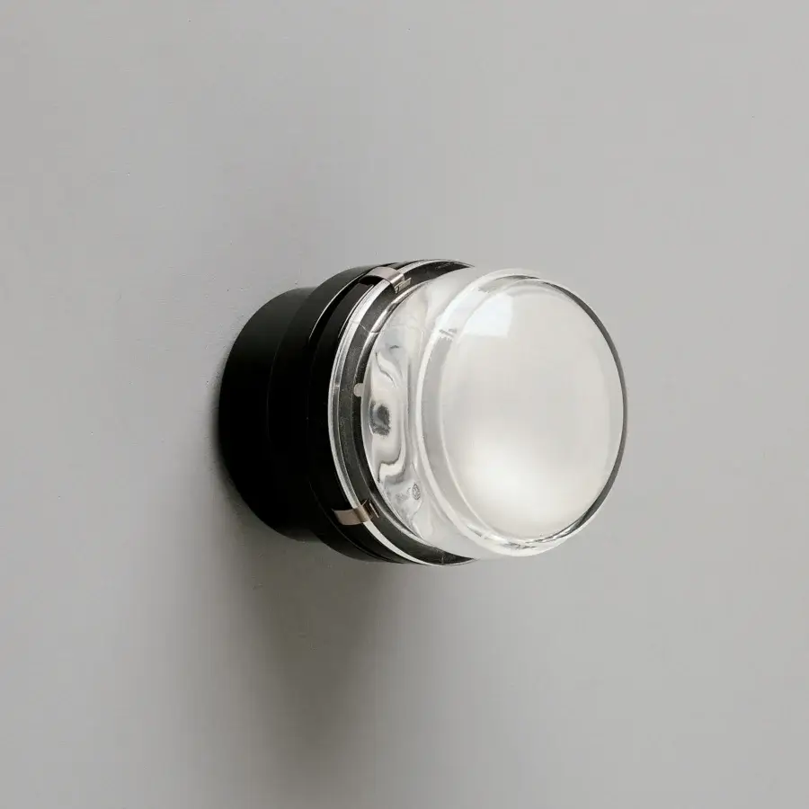 Distinguished Oluce Fresnel wall lamp crafted in matte black metal with a clear glass lens and subtle chrome accents