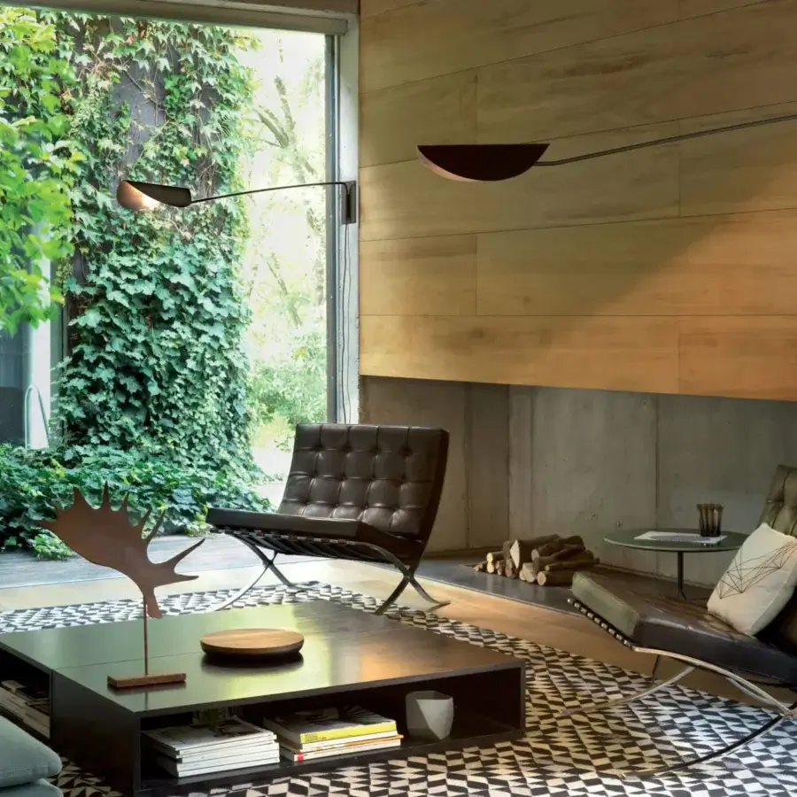 Elegant Oluce Plume wall lamp crafted in Italy with a curved form and satin dark bronze metal finish