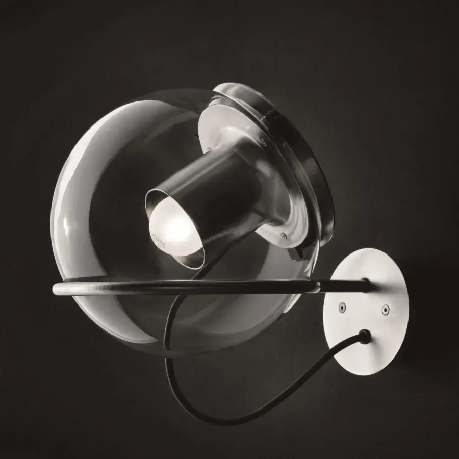 Superior Oluce Globe wall lamp crafted in Italy with a transparent blown-glass globe and satin metal reflector