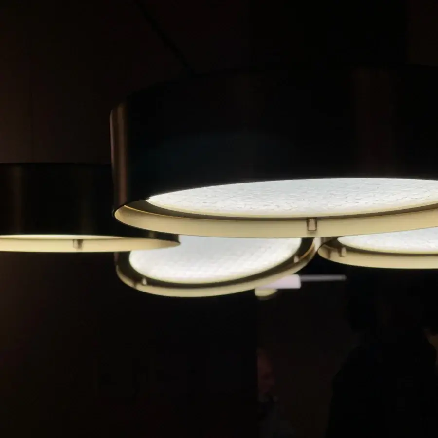 Superior Oluce Berlin suspension lamp with rotating shades and a dark matte finish in metal