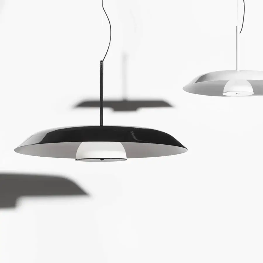 Elegant Oluce Iride suspension lamp crafted in metal with a black exterior and reflective white interior, boasting a glossy finish