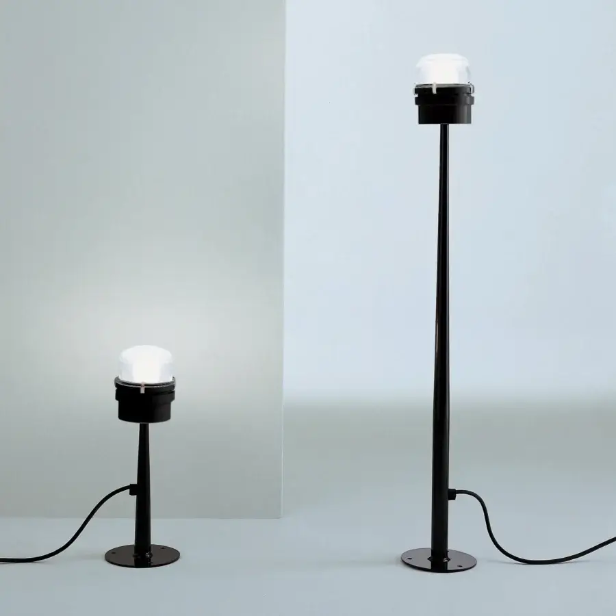 Distinguished Oluce Fresnel floor lamp with iconic lens and translucent white shades in matte black metal construction crafted in Italy