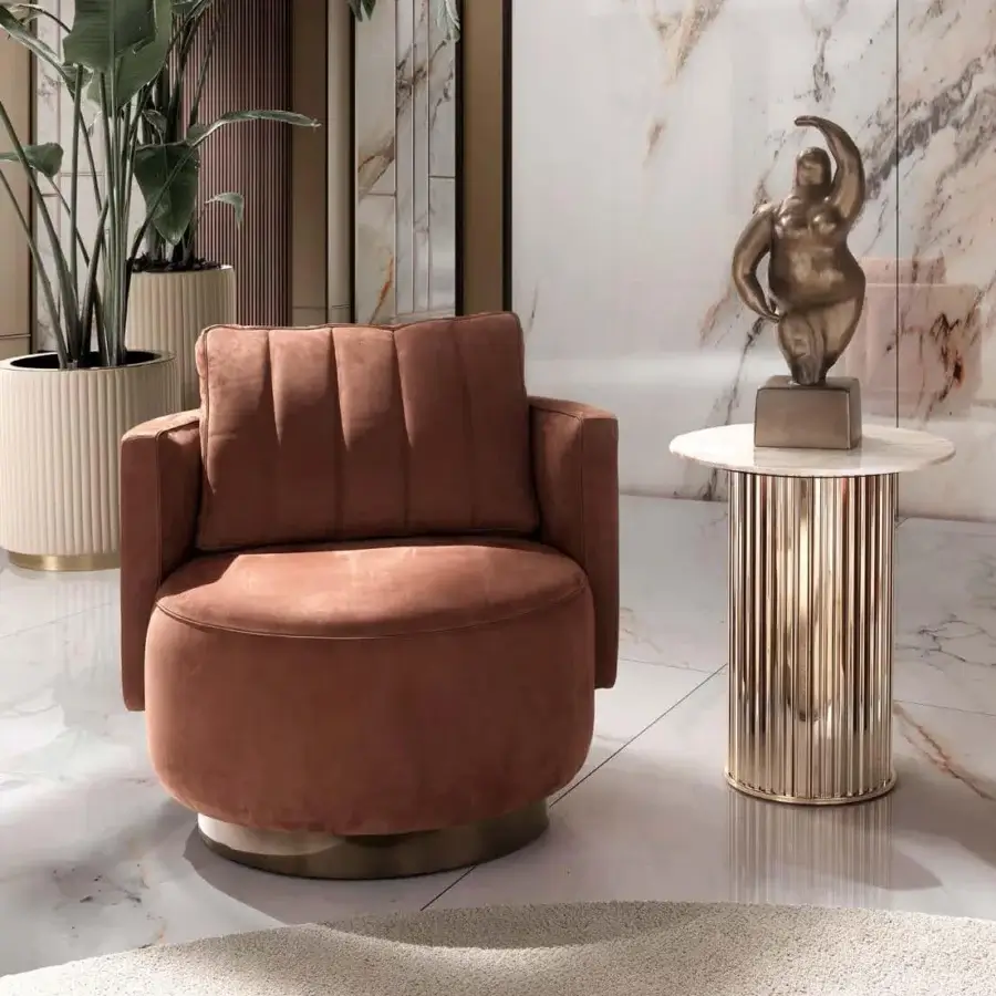 Lavish DV Home Collection Beverly lounge chair upholstered in matte terracotta fabric with a shining stainless steel swivel base