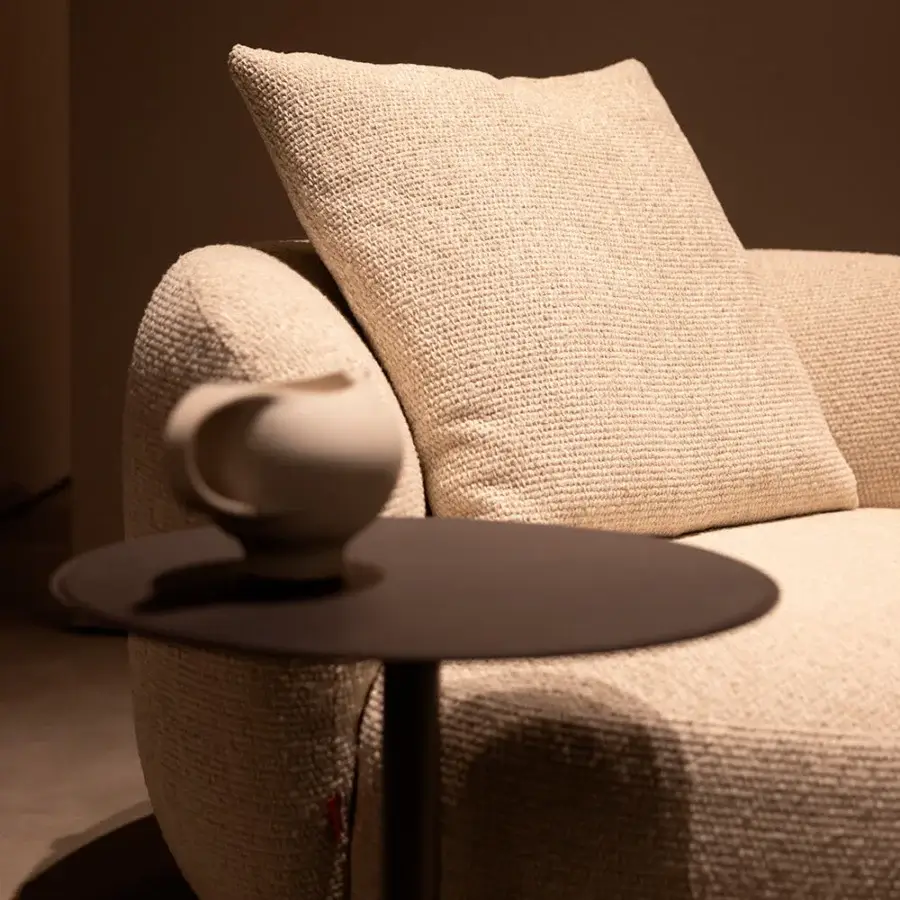 Distinguished Verzelloni Vic lounge chair with fully rounded form upholstered in warm neutral beige boucle fabric and iron frame