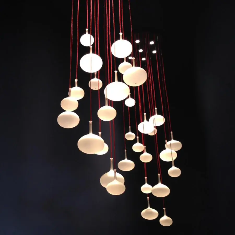 Captivating melogranoblu Hydra Onion suspension lamp with frosted hand-blown glass shades and mirror-finish metal ceiling crafted with vibrant red metallic cords