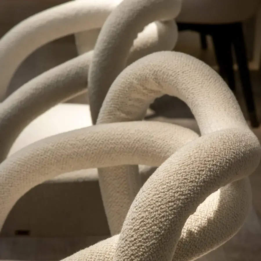 Exceptional Rugiano Abbraccio armchair with uniquely knotted form upholstered in textured neutral cream bouclé fabric and bronzed brass details