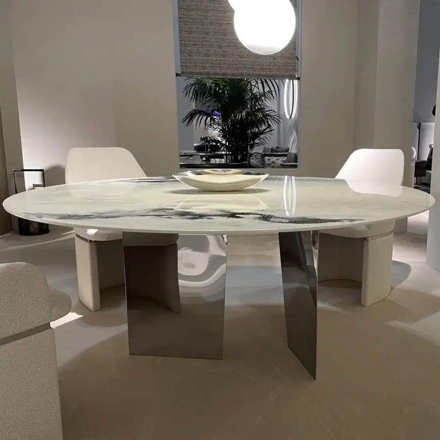 Elegant Rugiano Blanco table with striking marble tabletop and polished metal base crafted in an elongated oval form
