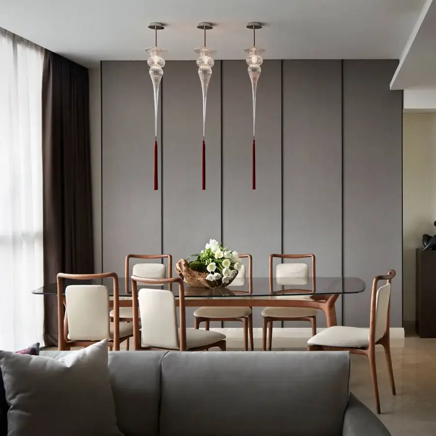 Distinguished melogranoblu Opera - Turandot suspension lamp built with hand-blown clear glass and a light-colored metal fixture with silk tassel