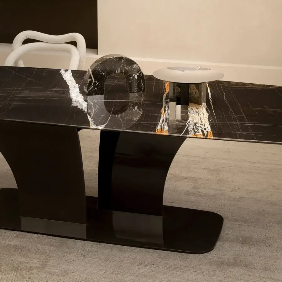 Elegant Rugiano Spectro table with a refined marble tabletop and dramatically sculpted bronze base in a deep black finish