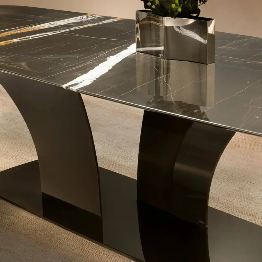 Superior Rugiano Spectro table with a sculpted high-gloss bronze base and charcoal marble tabletop exhibiting white gold veining