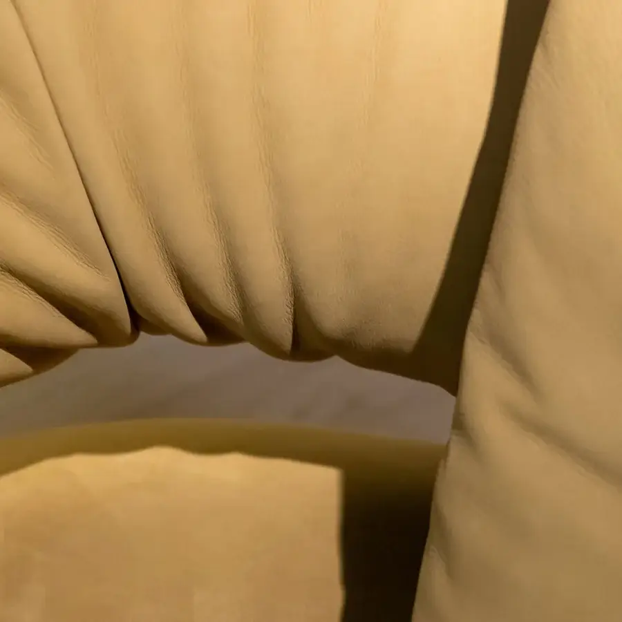Lavish Rugiano Abbraccio sofa with organically curved form upholstered in muted yellow leather and bronzed brass accents