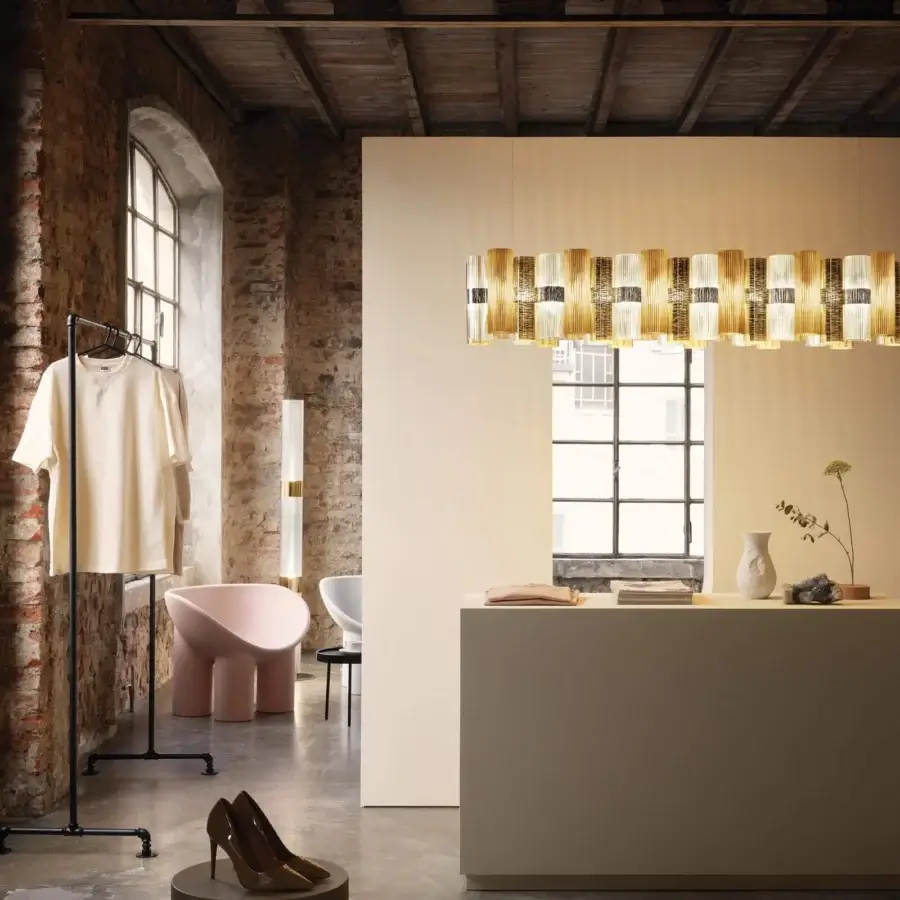 Distinguished Slamp La Lollo Linear suspension lamp crafted in Lentiflex® with a cold foil Opalflex® finish emitting a warm golden-yellow glow
