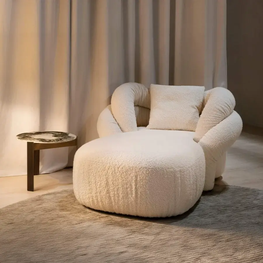 Lavish Rugiano Abbraccio chaise lounge crafted in bouclé fabric with bronzed brass details for ultimate relaxation