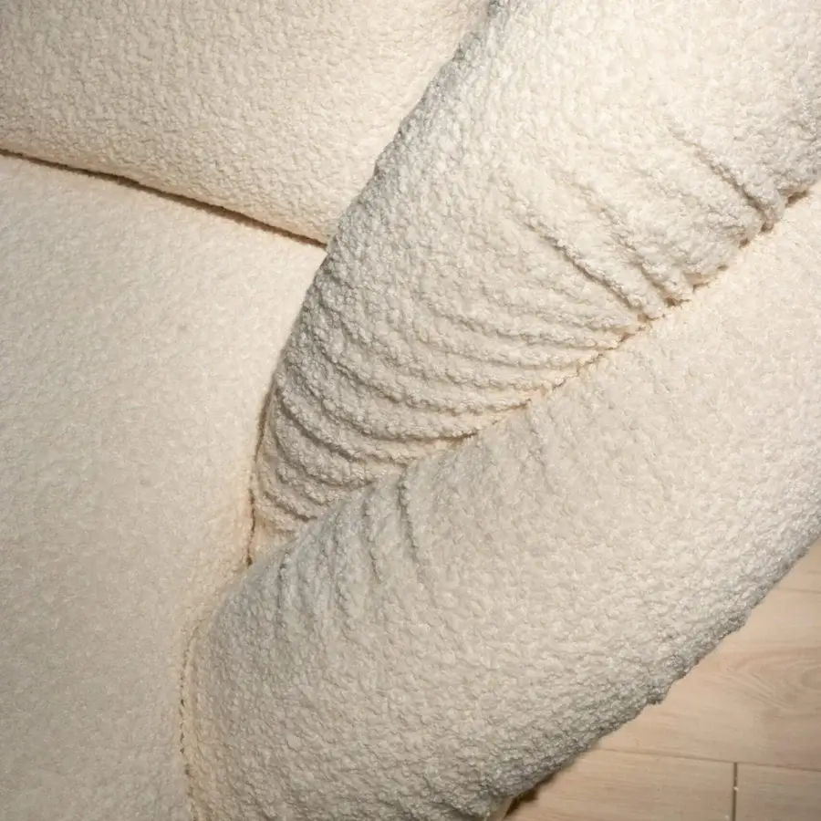 Distinguished Rugiano Abbraccio chaise lounge upholstered in creamy off-white textured bouclé fabric with subtle bronzed brass details