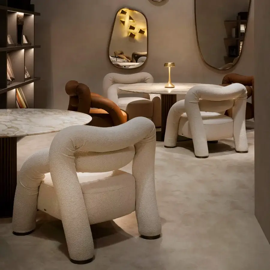 Distinguished Rugiano Abbraccio lounge chair crafted in creamy off-white fabric with elegant Bronzed Brass details