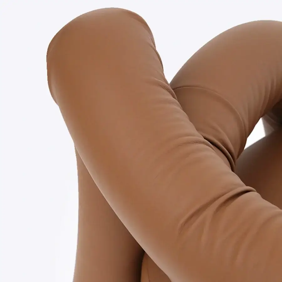 Lavish Rugiano Abbraccio lounge chair with enveloping sculptural form in smooth light brown leather and satin finish