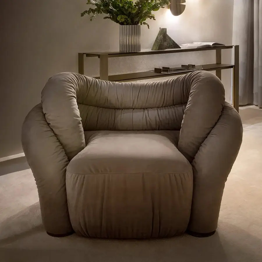 Distinguished Rugiano Abbraccio lounge chair crafted in warm beige fabric with bronzed brass base details