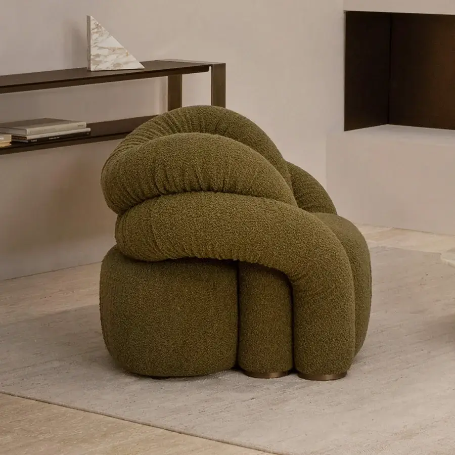 Distinguished Rugiano Abbraccio lounge chair upholstered in textured olive green bouclé-like fabric with bronzed brass details