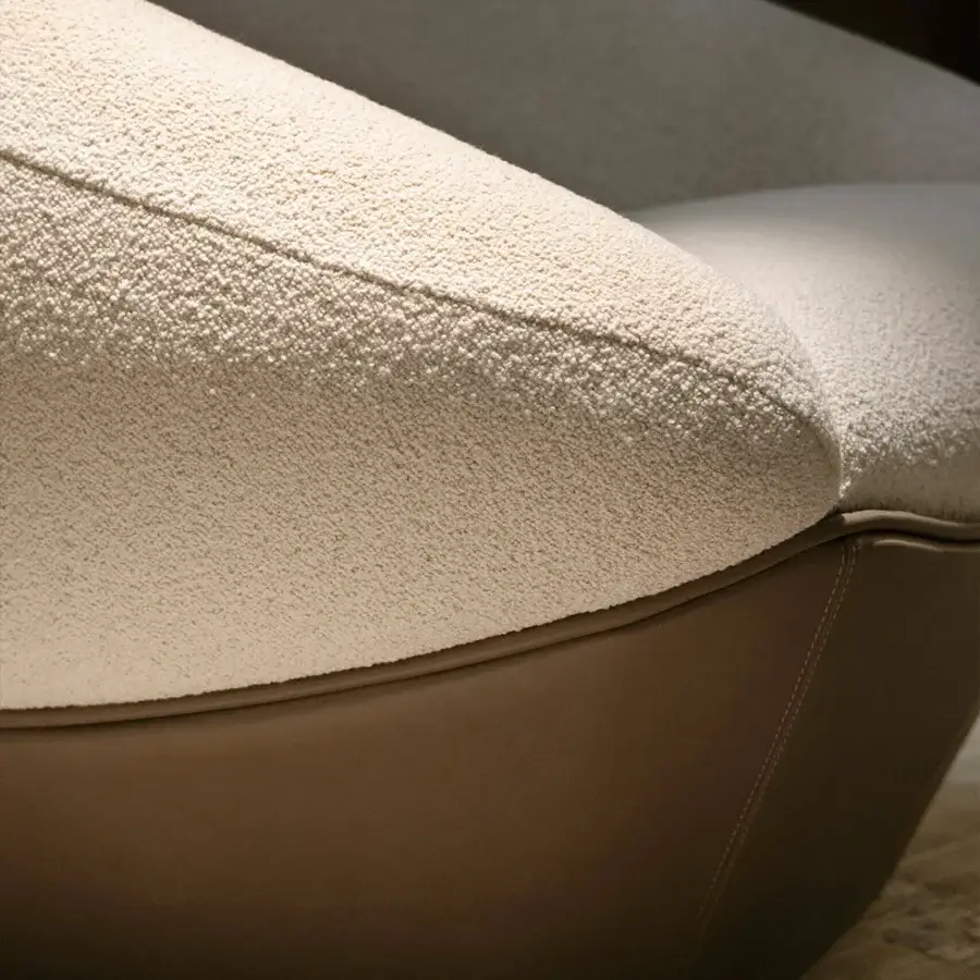 Exceptional Rugiano Iside lounge chair with uniquely faceted silhouette and cream textured fabric with brown leather base