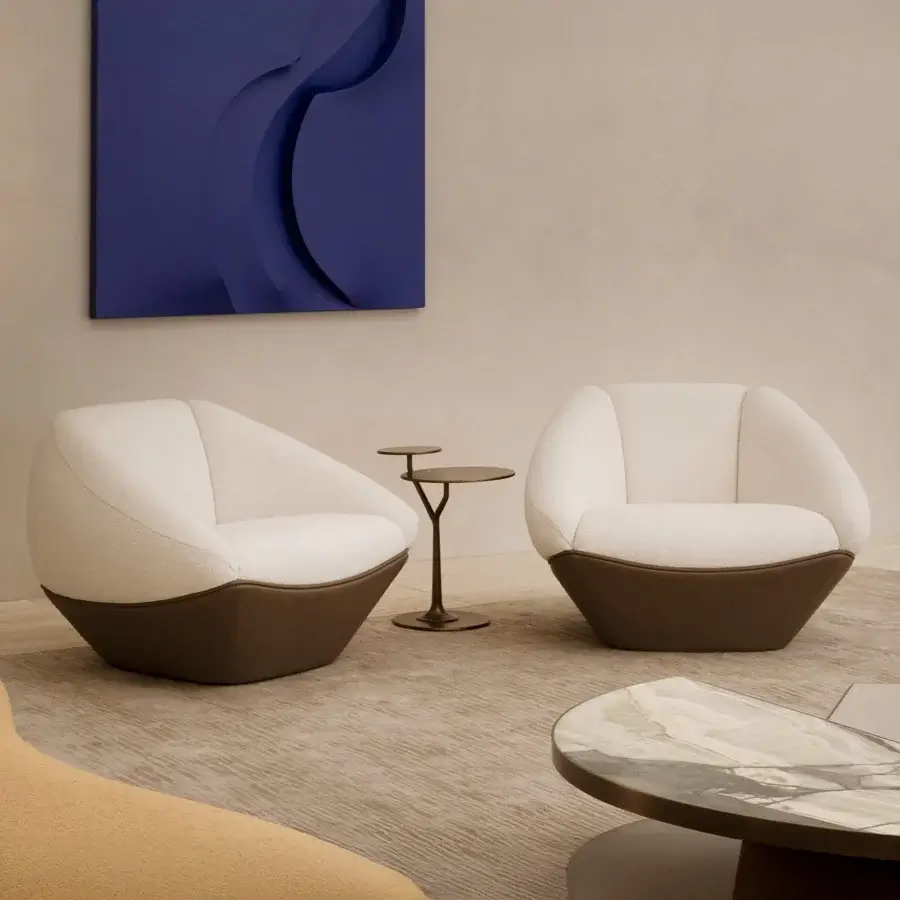 Superior Rugiano Iside lounge chair with uniquely faceted silhouette upholstered in textured off-white fabric and dark-toned leather base
