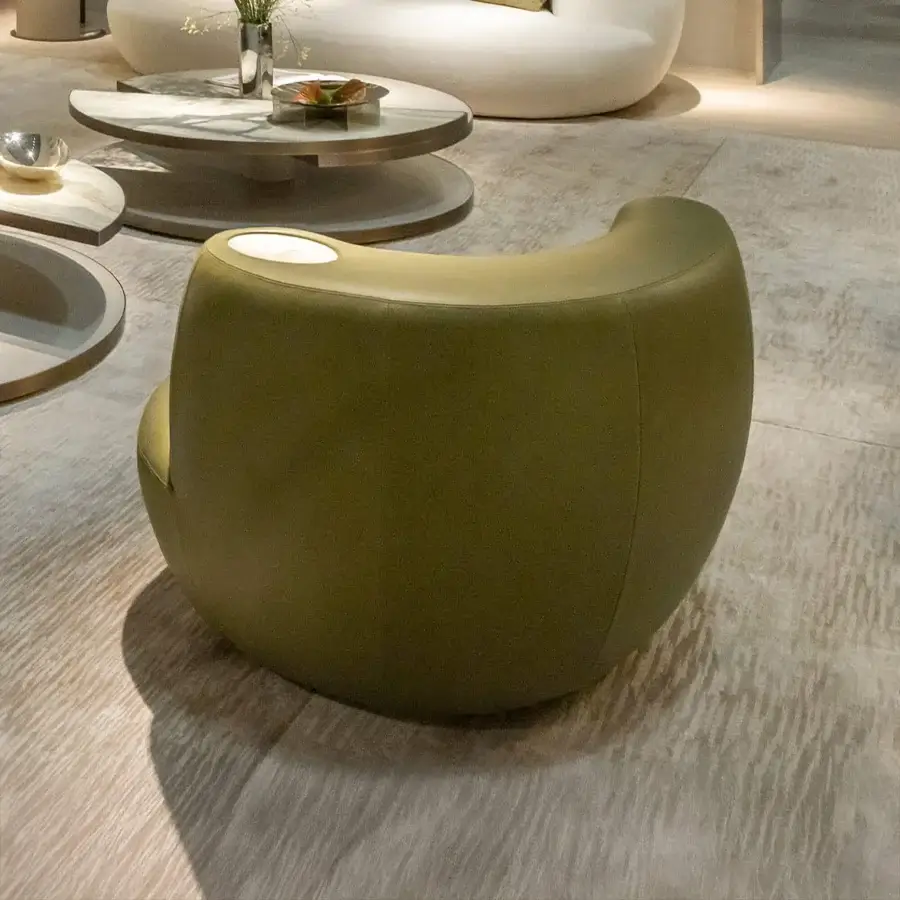 Captivating Rugiano Rafael lounge chair with asymmetric silhouette upholstered in matte olive green fabric and integrated marble detail