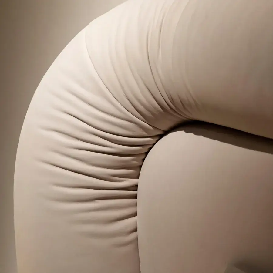 Lavish Rugiano Loom bed with a continuously curved headboard upholstered in neutral beige fabric with a smooth matte finish