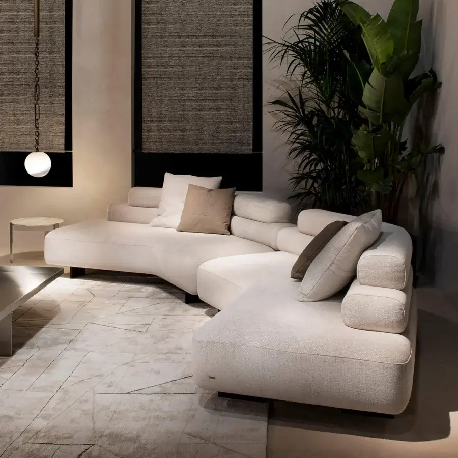Exceptional Rugiano Bali sectional with plush cylindrical cushions upholstered in textured woven beige fabric with bronzed brass details