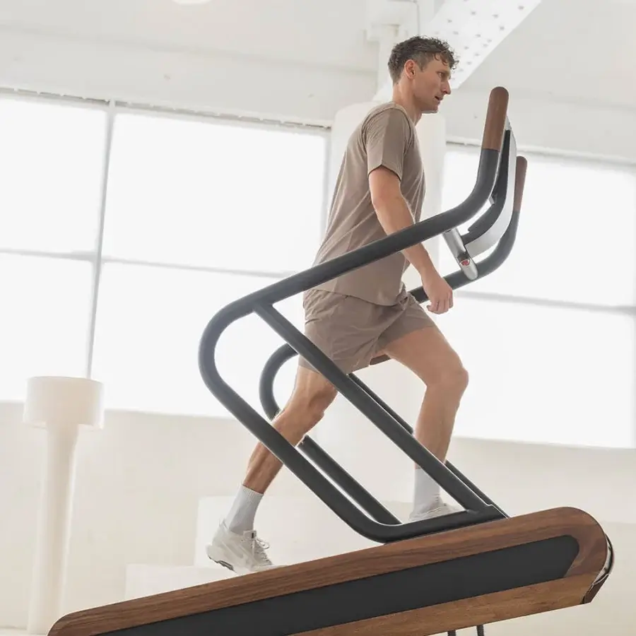 Elegant NOHRD Citius treadmill crafted from fine woods and precision-engineered metal with a matte black finish