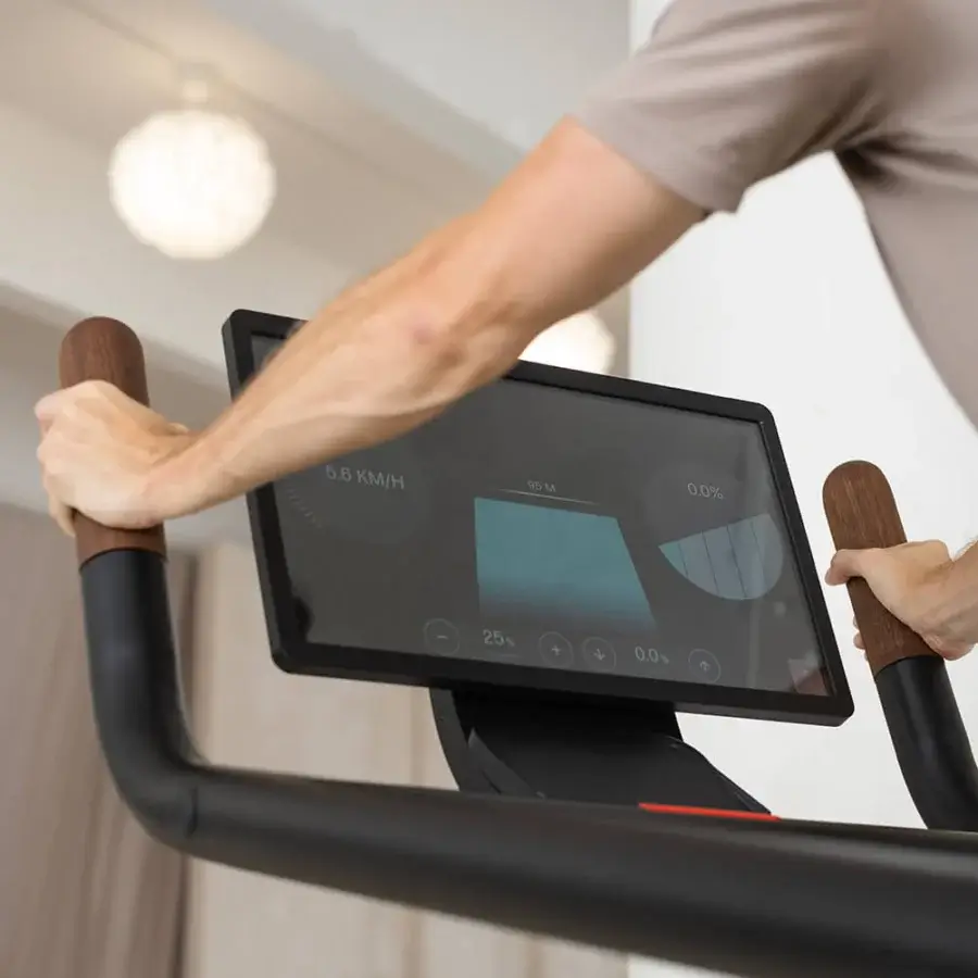 Elegant NOHRD Citius treadmill crafted with precision-engineered metal and light-toned wooden handles in a matte dark gray finish