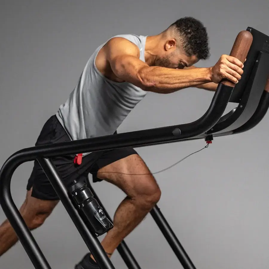 Exceptional NOHRD Citius treadmill built with warm wood tones and matte black metal for a remarkably natural running experience